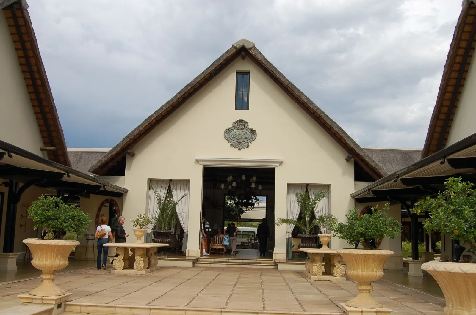 Thatched entrance and paved courtyard of the Royal Livingstone Hotel