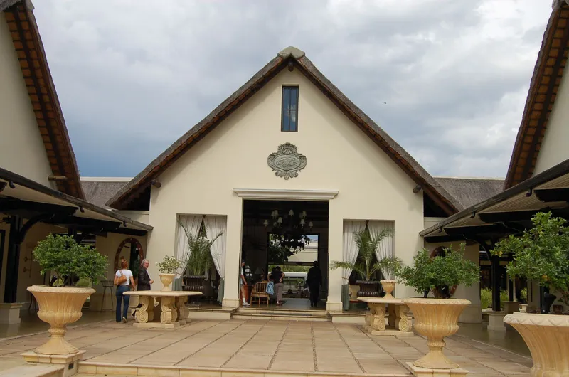 Thatched entrance and paved courtyard of the Royal Livingstone Hotel