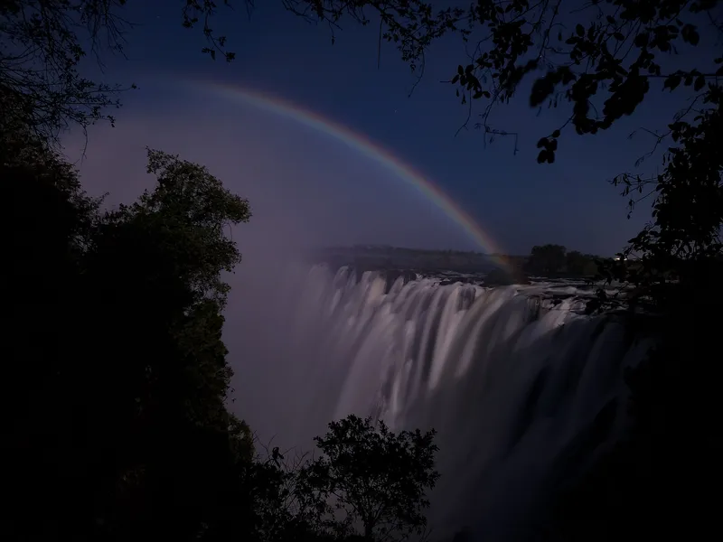 A moonbow over the falls at night, seen from the Zambian side