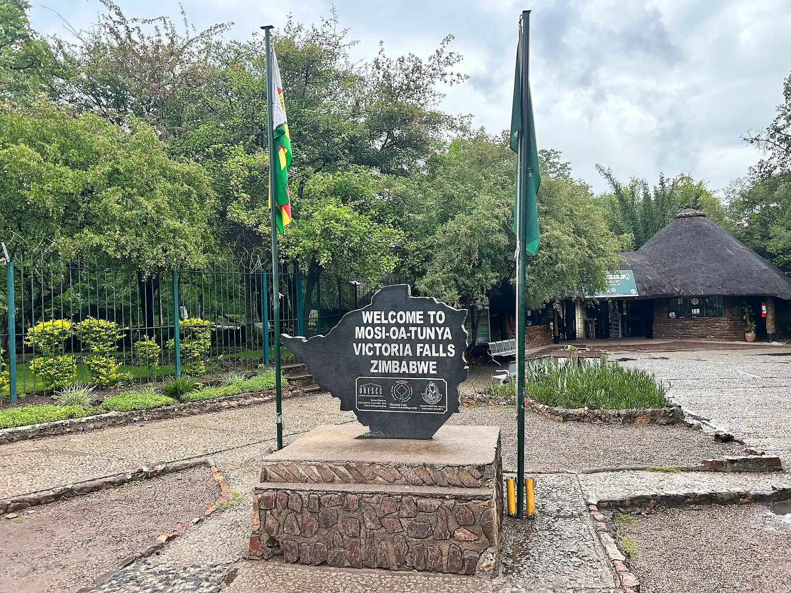 Welcome sign and flags at the entrance to the falls park on the Zimbabwe side