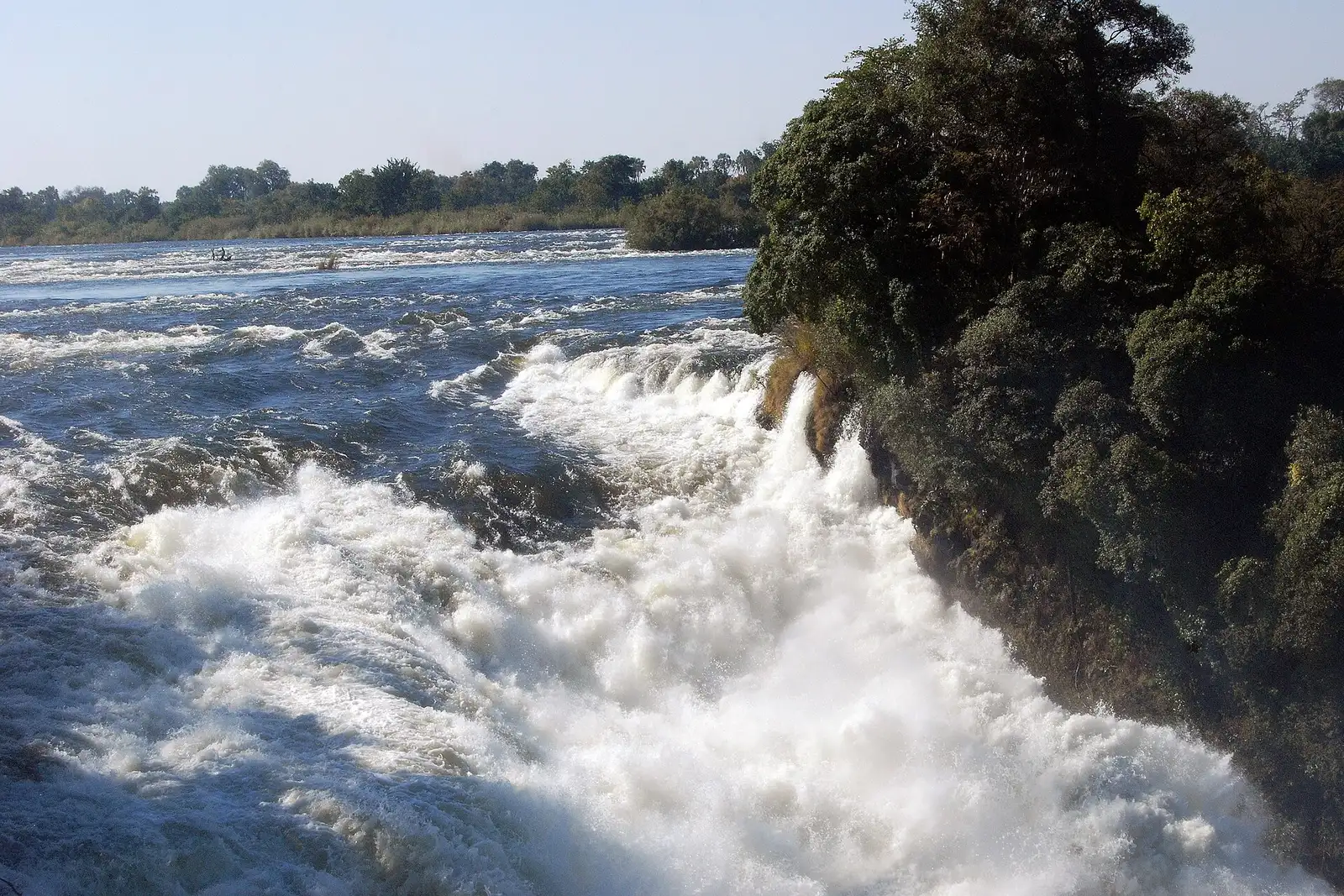 The Zambezi rushing over rocks toward the edge of the falls