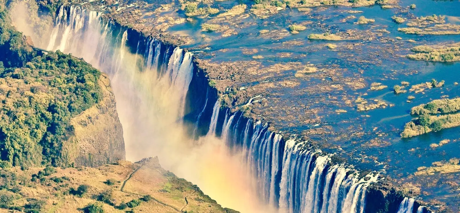 Aerial view of the falls with spray, islands in the river above