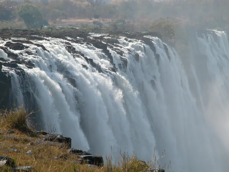 Water pouring over the rocky lip of the falls, close view from the edge